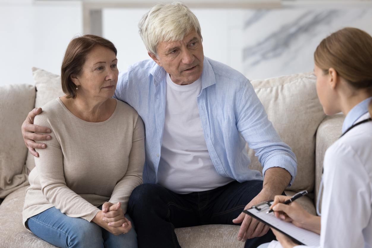 a couple talking with a healthcare professional